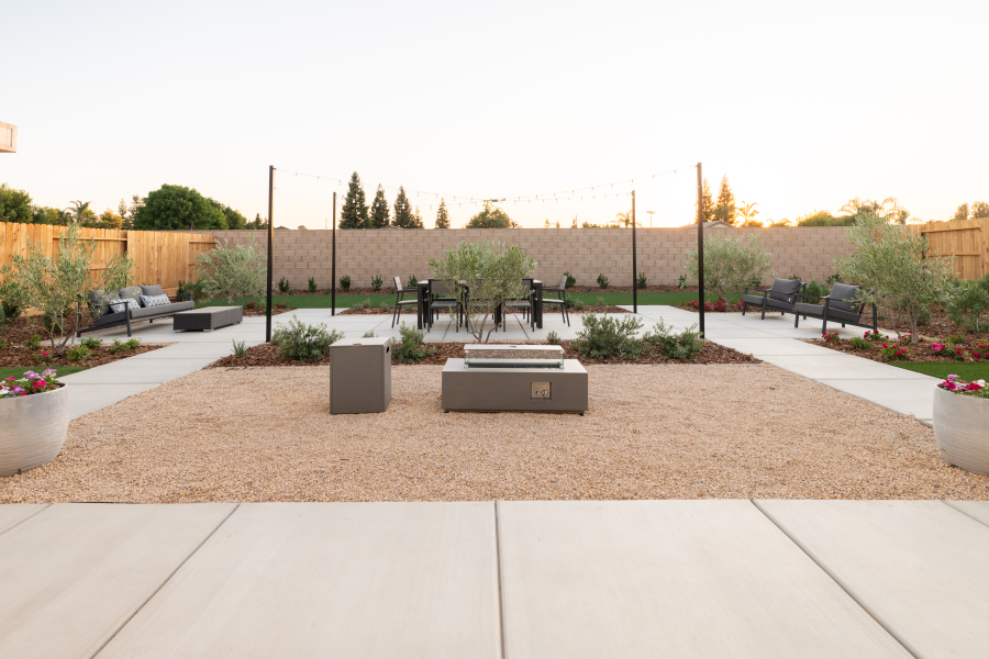 A courtyard with a few chairs and a few plants.