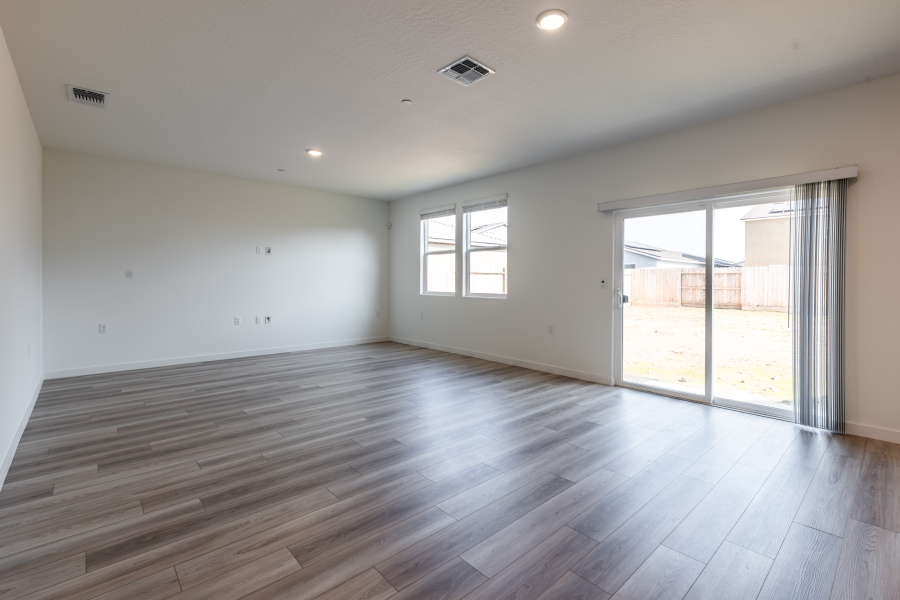 A room with a wood floor and a glass door.