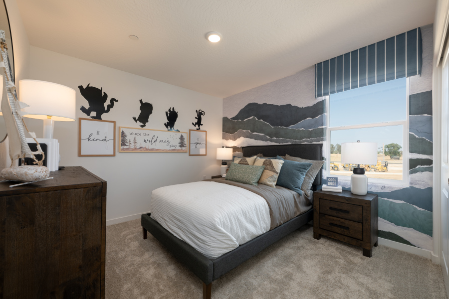 A bedroom with a bed and a window.