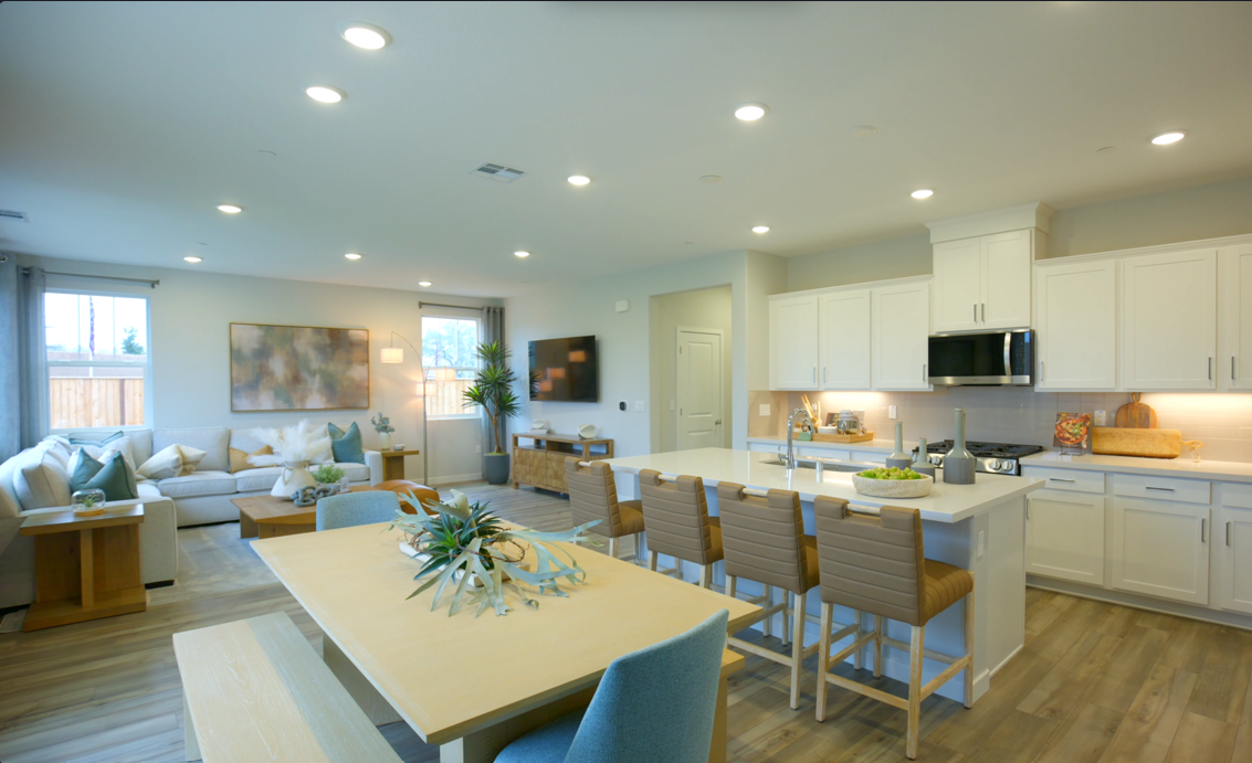 A large kitchen with a dining table.