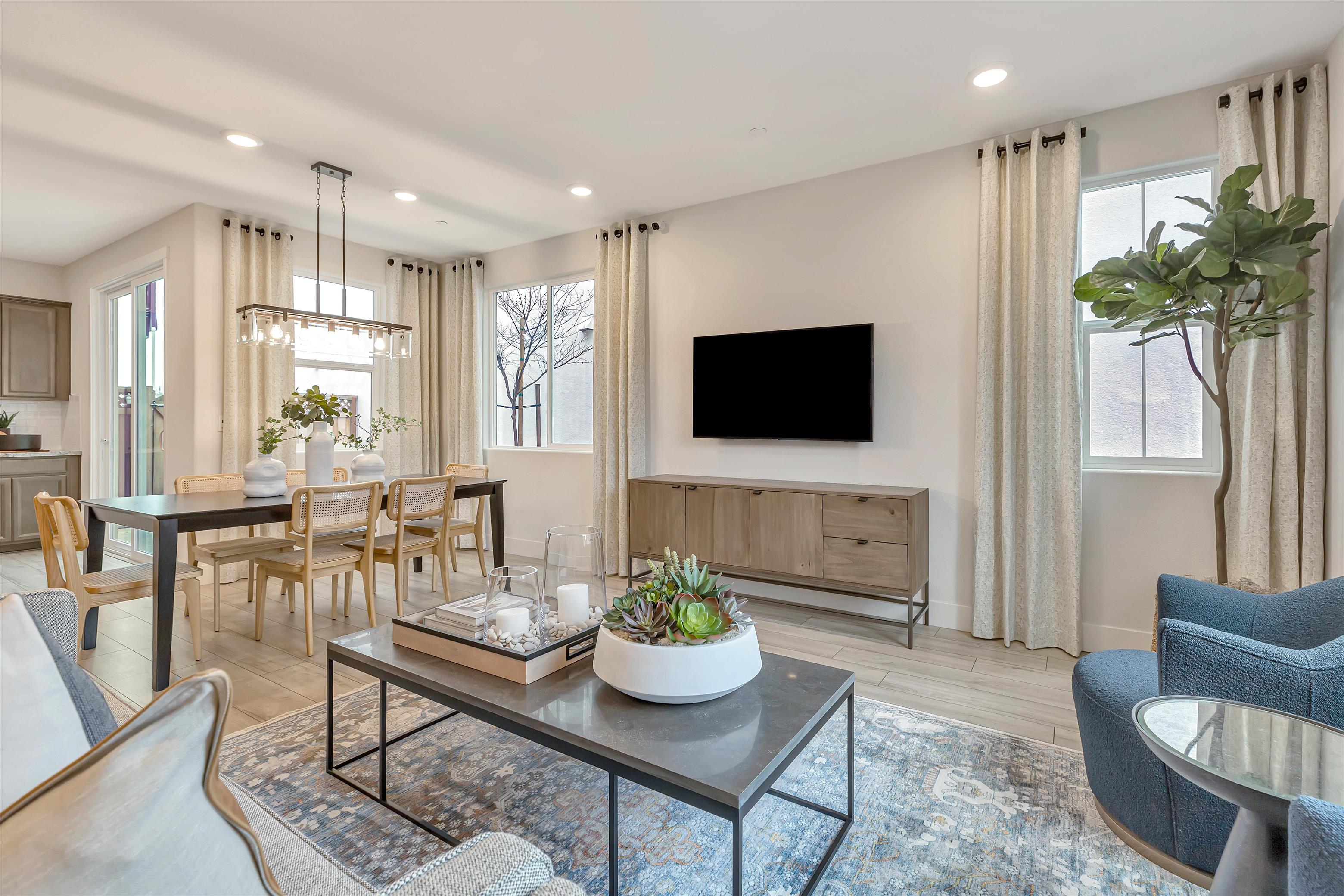 A living room with a tv and chairs.