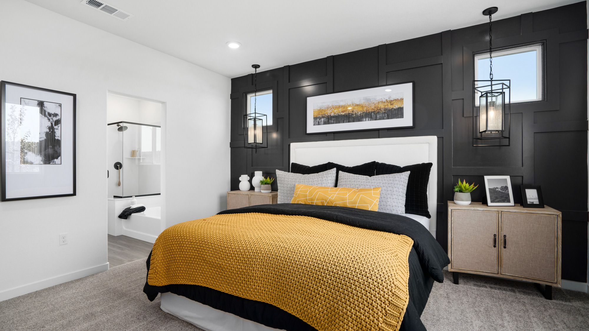 A bedroom with a bed and a mirror.