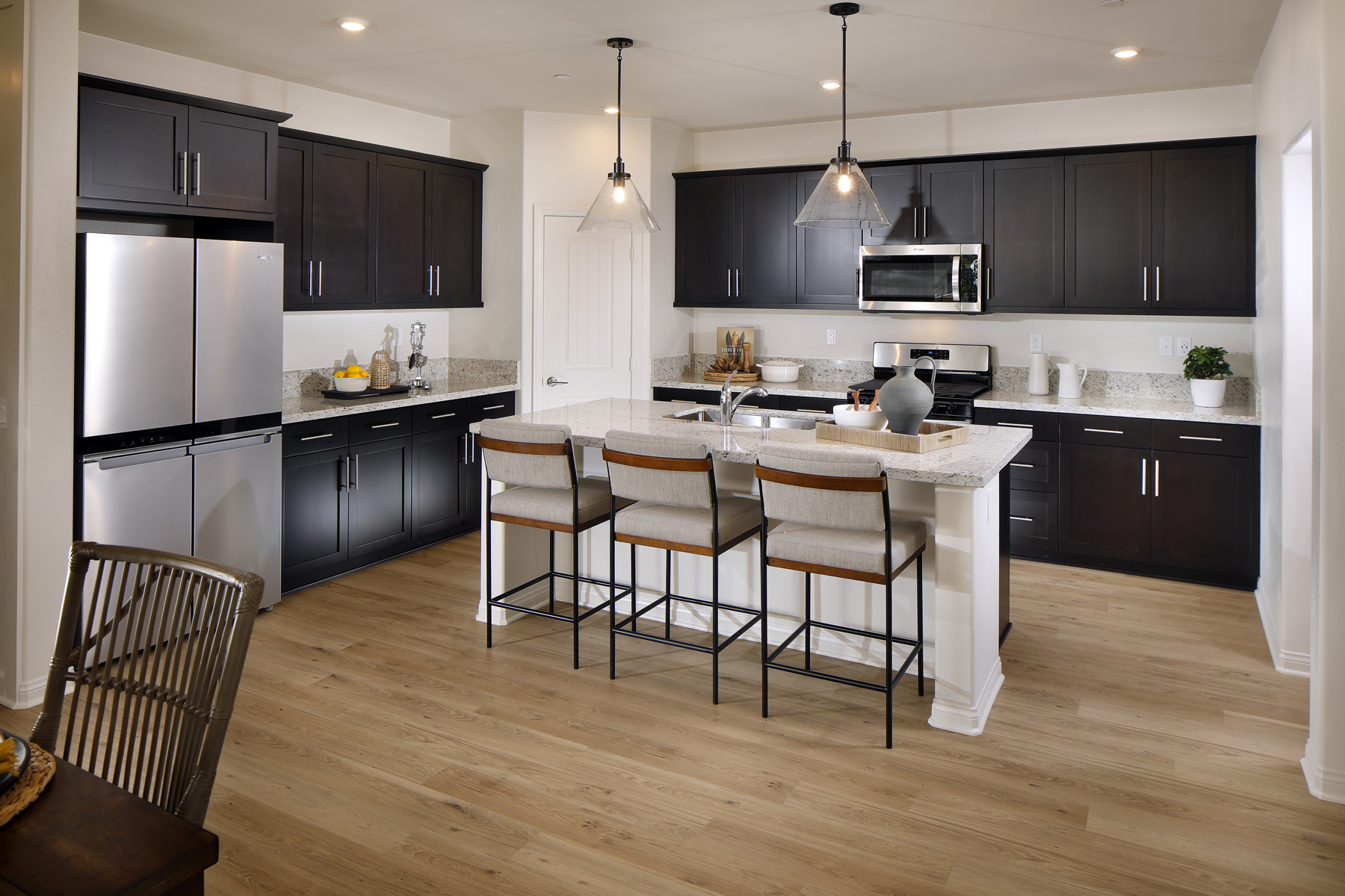 A kitchen with black cabinets.