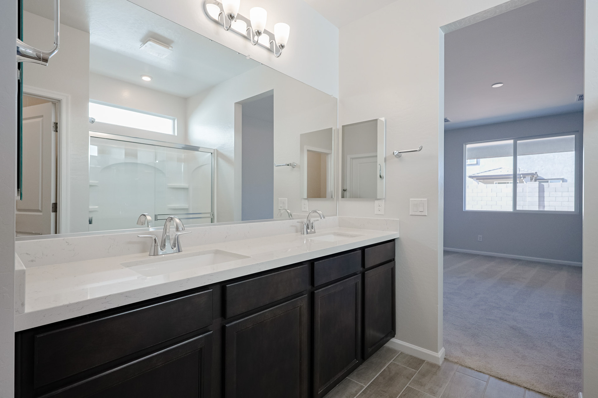 A bathroom with a large mirror.