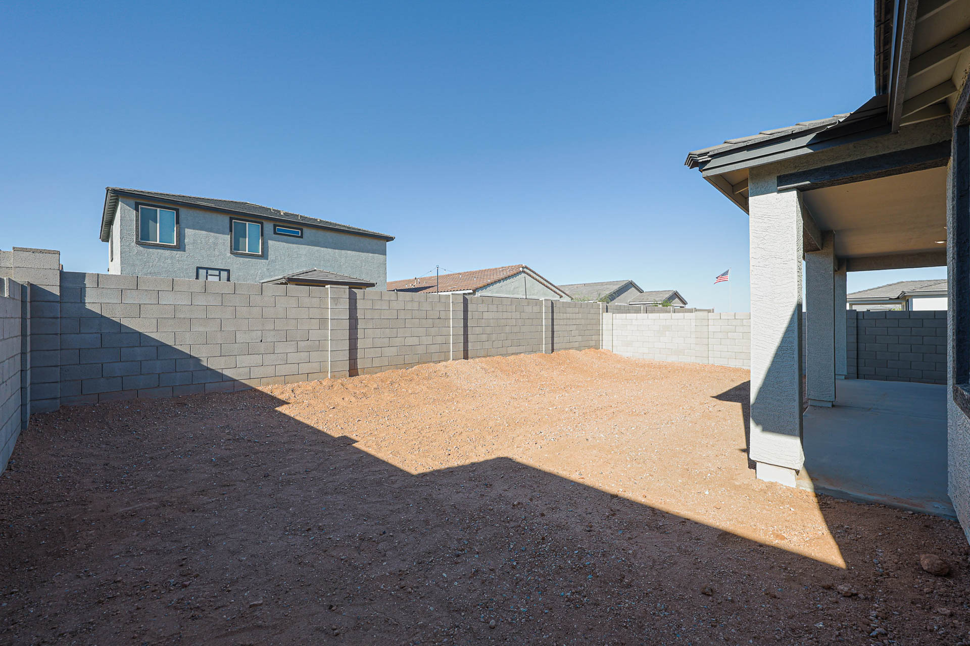A dirt path between two buildings.