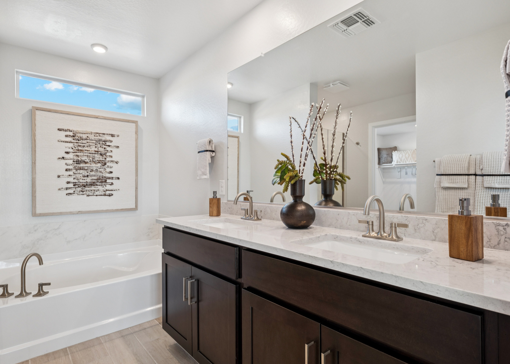A bathroom with a large mirror.