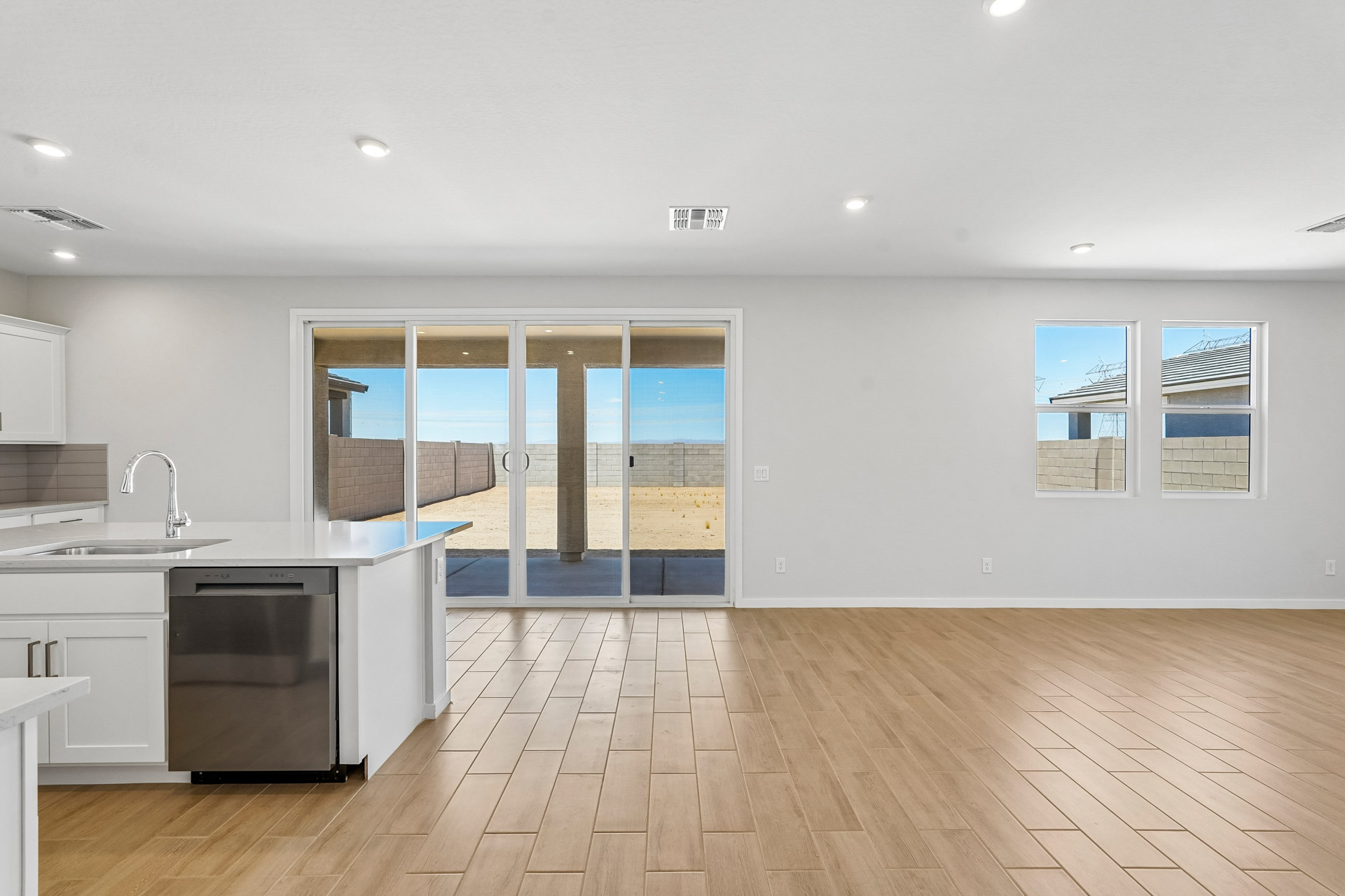 A kitchen with a wood floor.