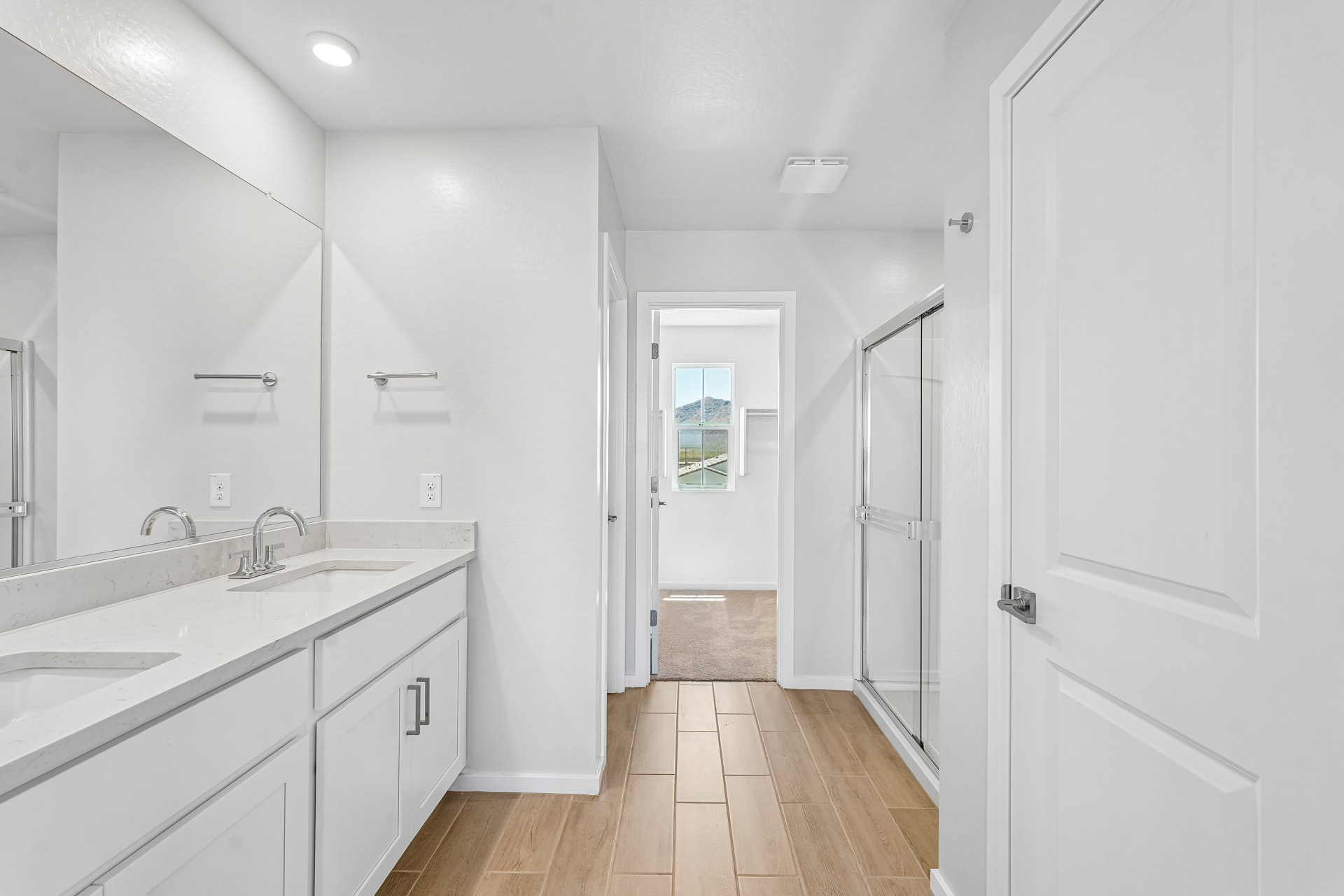 A bathroom with white cabinets.