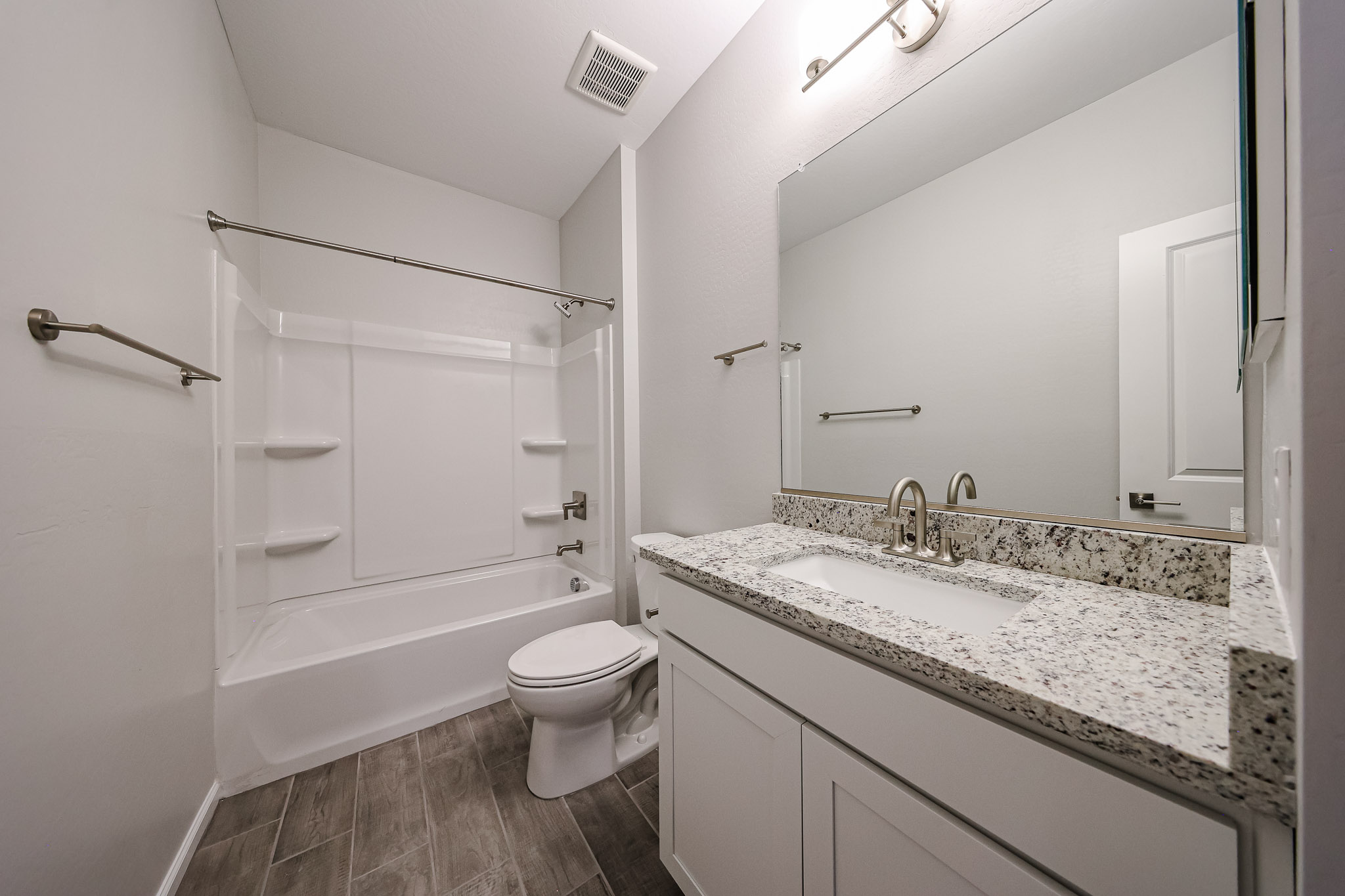 A bathroom with a tub sink and toilet.