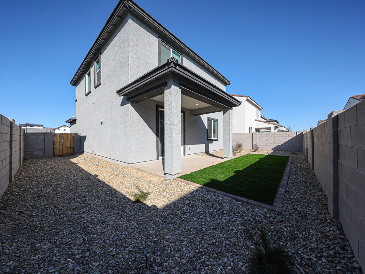 A house with a stone driveway.