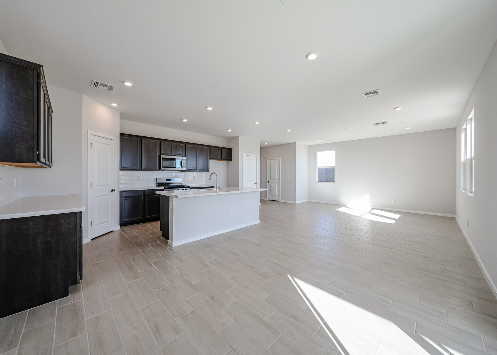 A large kitchen with wooden floors.