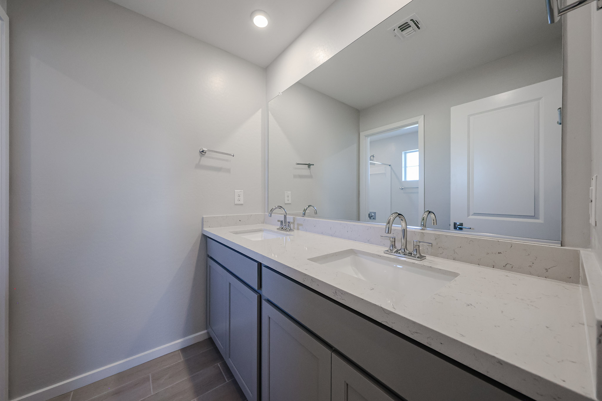 A bathroom with a large mirror.