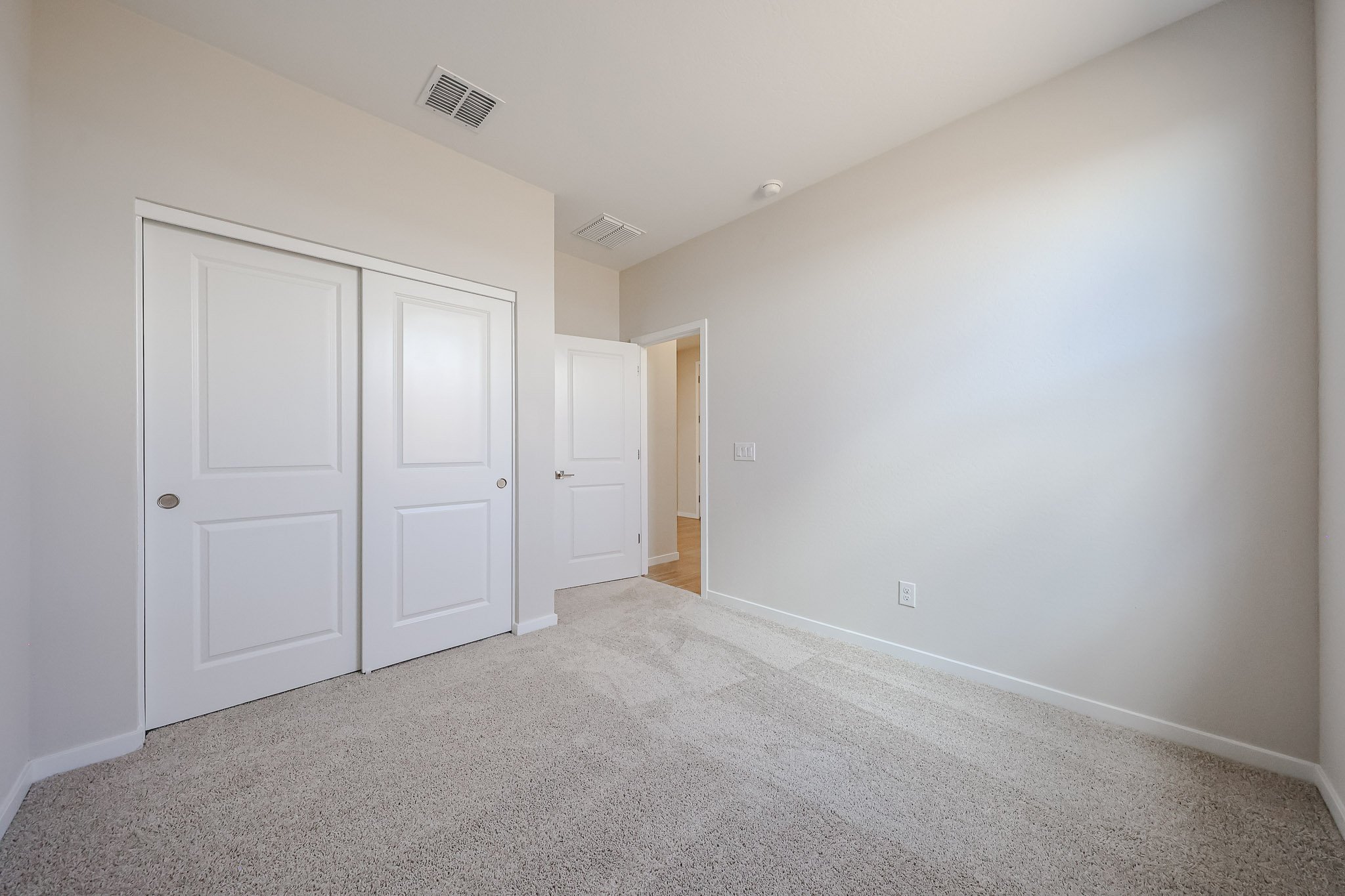 A hallway with white doors.