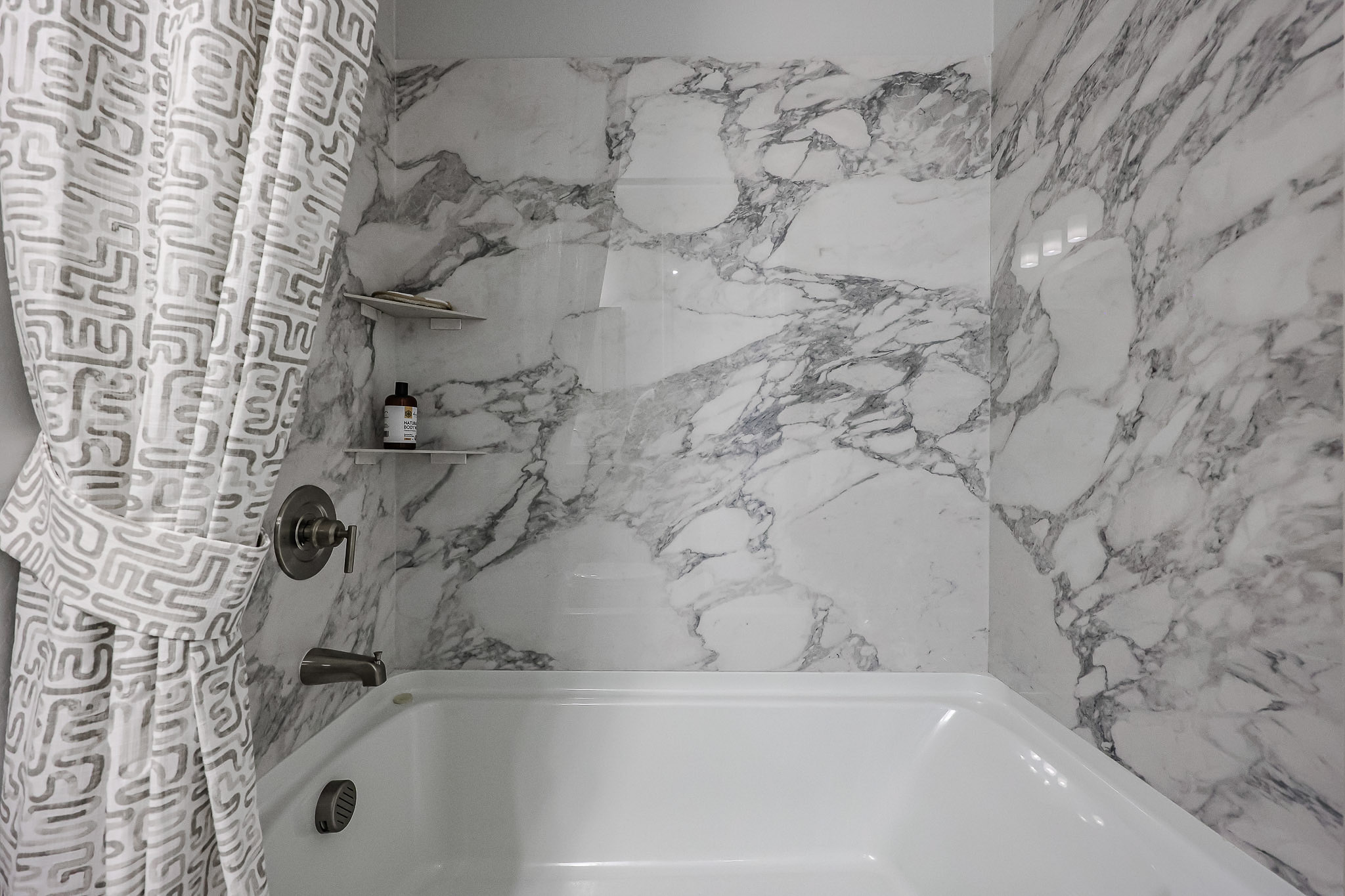 A bathroom with a tub and sink.