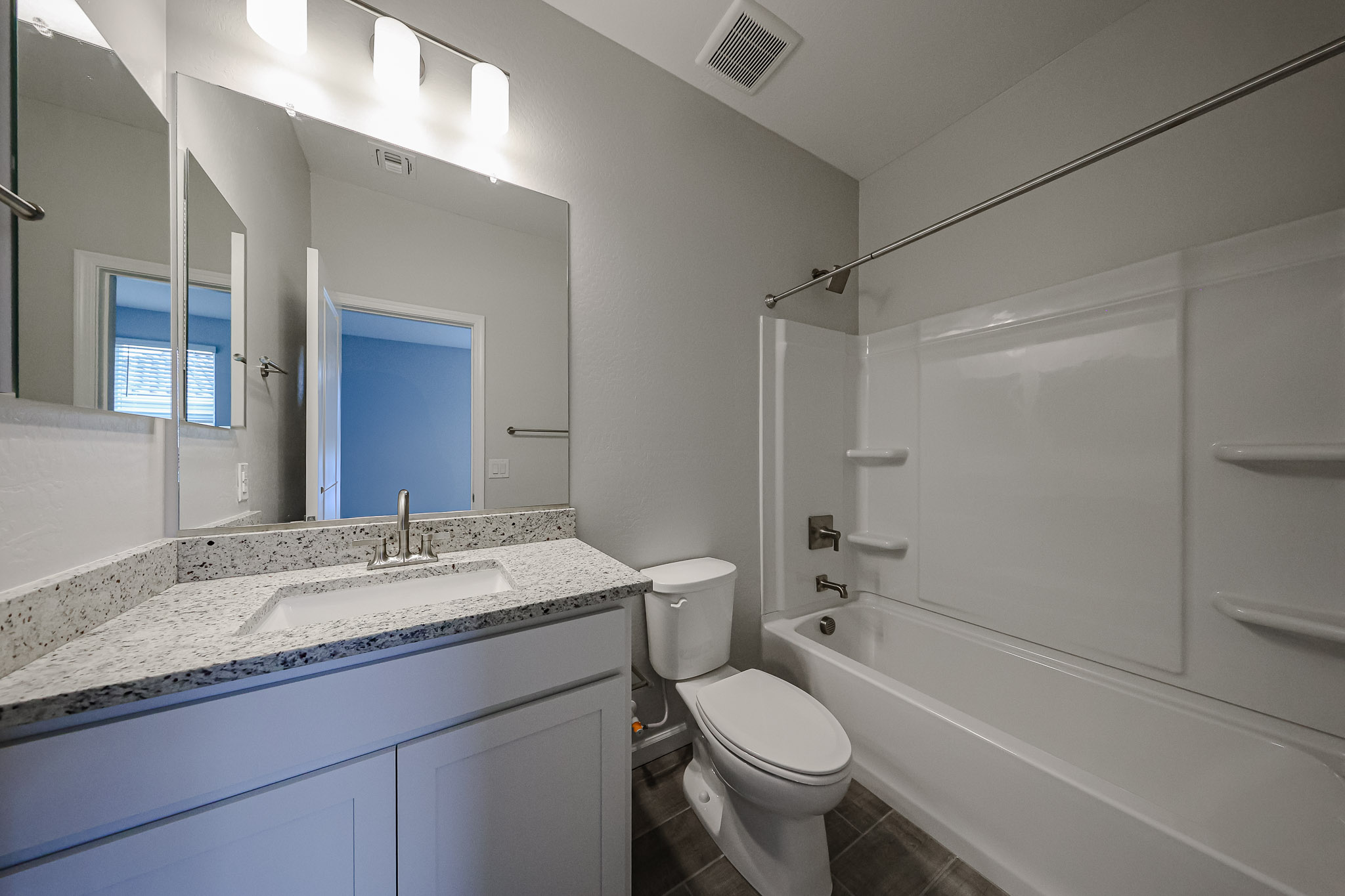 A bathroom with a tub sink and toilet.