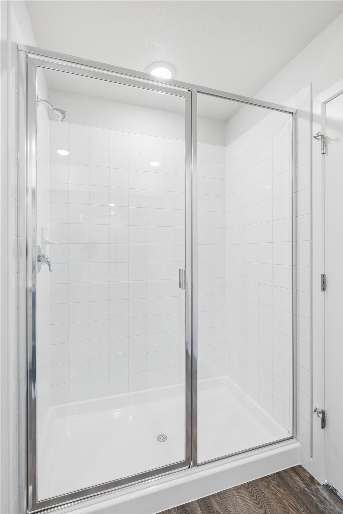 A shower with a glass door.