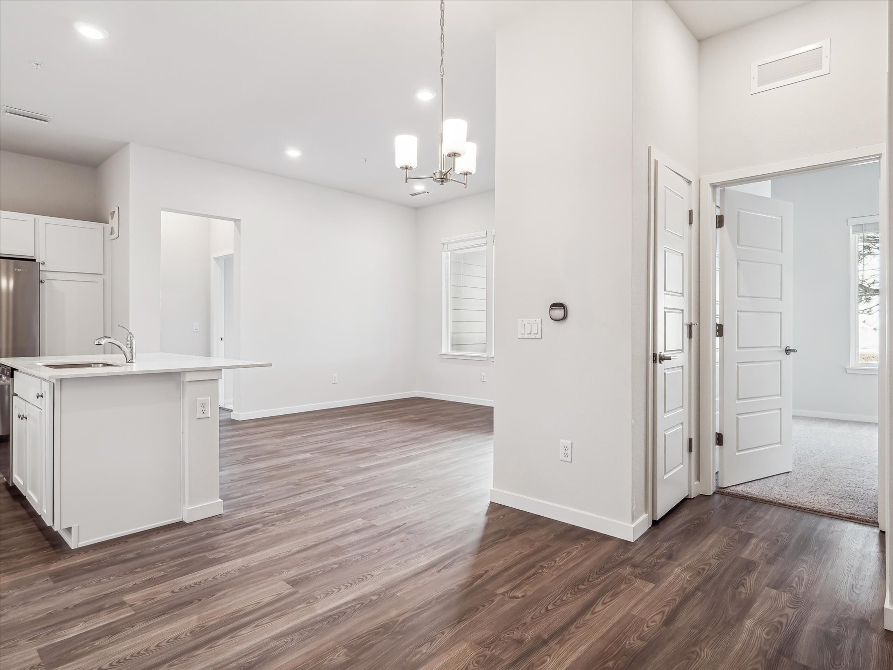 A kitchen with white walls.