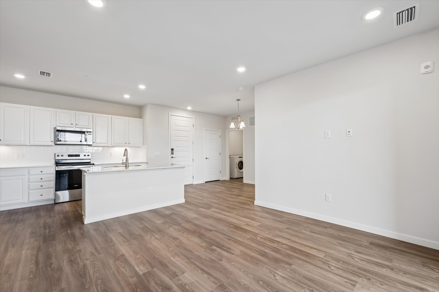 A kitchen with white cabinets.