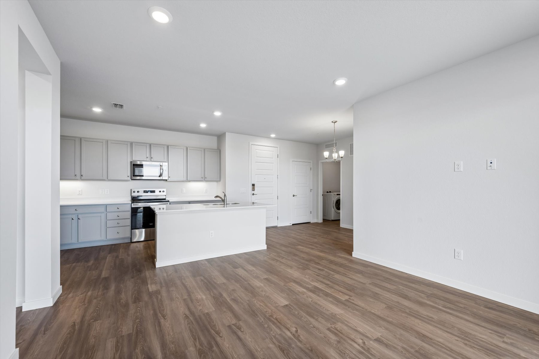 A kitchen with white cabinets.