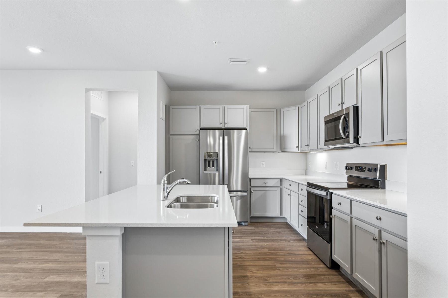 A kitchen with white cabinets.