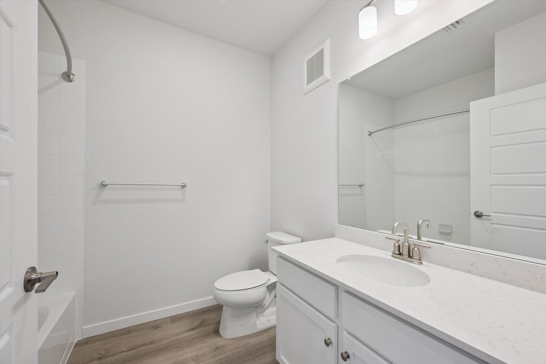 A bathroom with a sink toilet and shower.