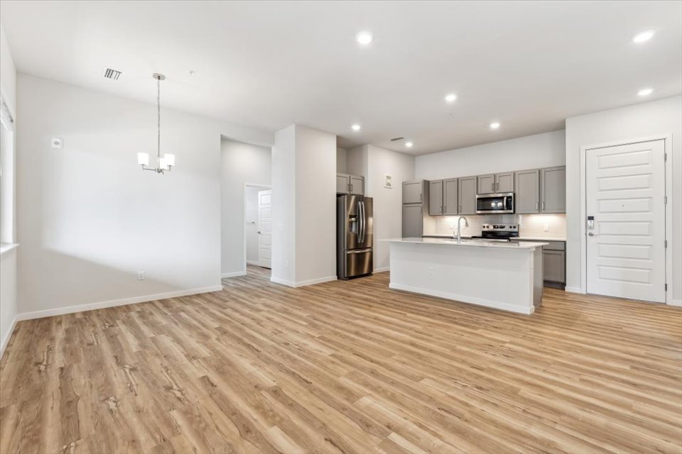 A kitchen with white cabinets.