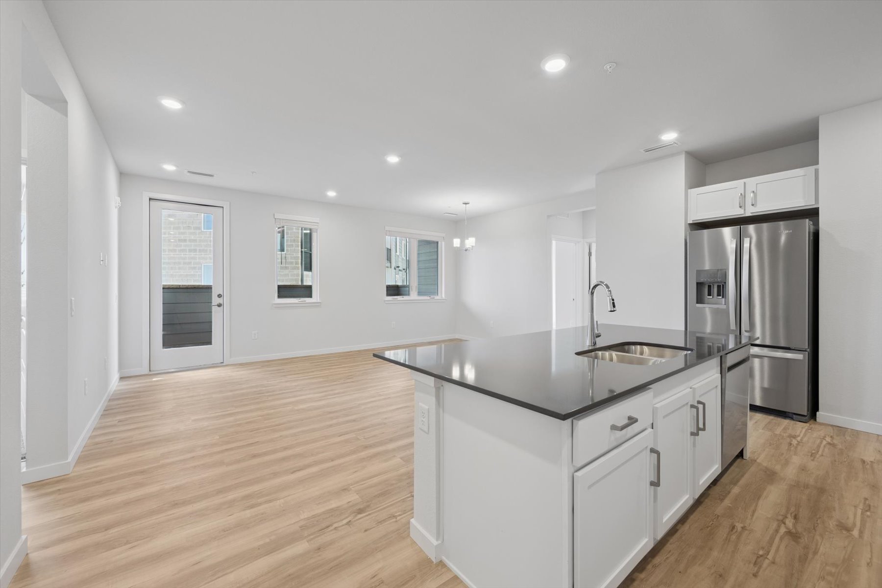 A kitchen with white cabinets.
