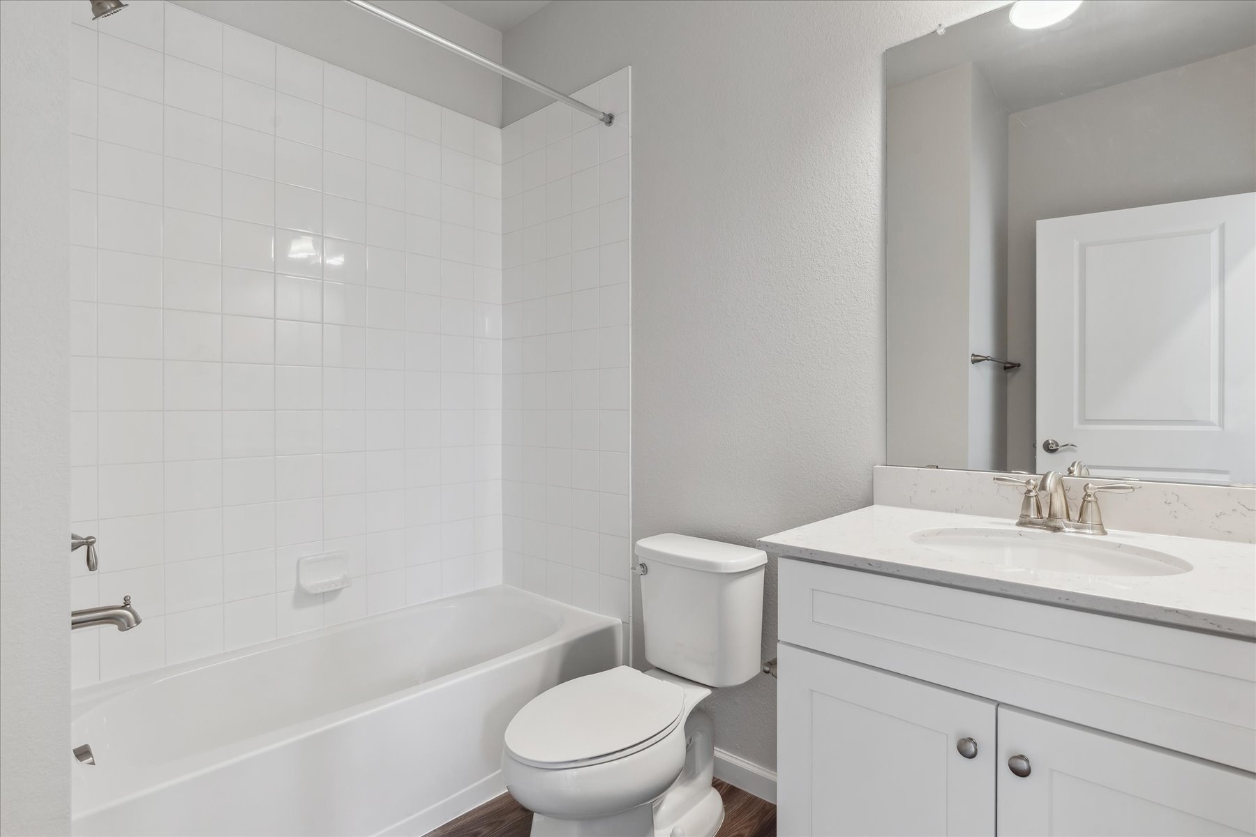 A bathroom with a tub sink and toilet.