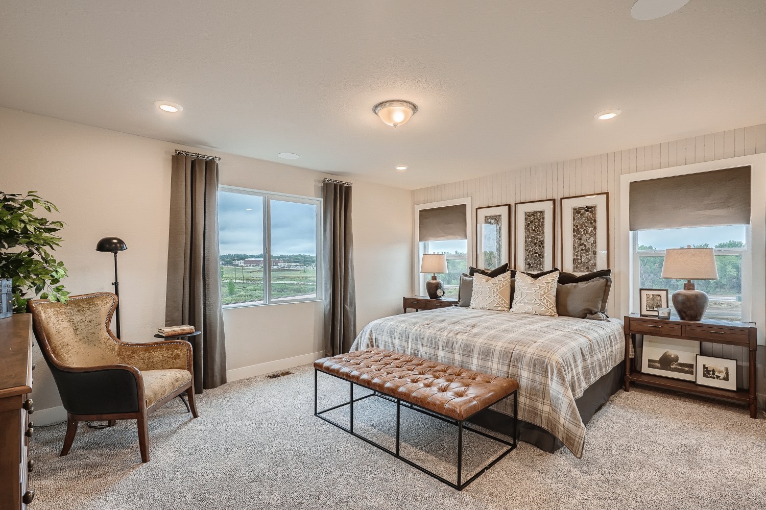 A bedroom with a bed and a chair.