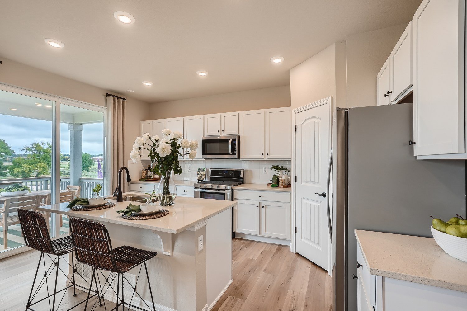 A kitchen with white cabinets.