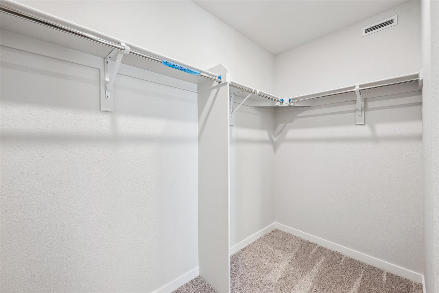 A white staircase with a metal railing.