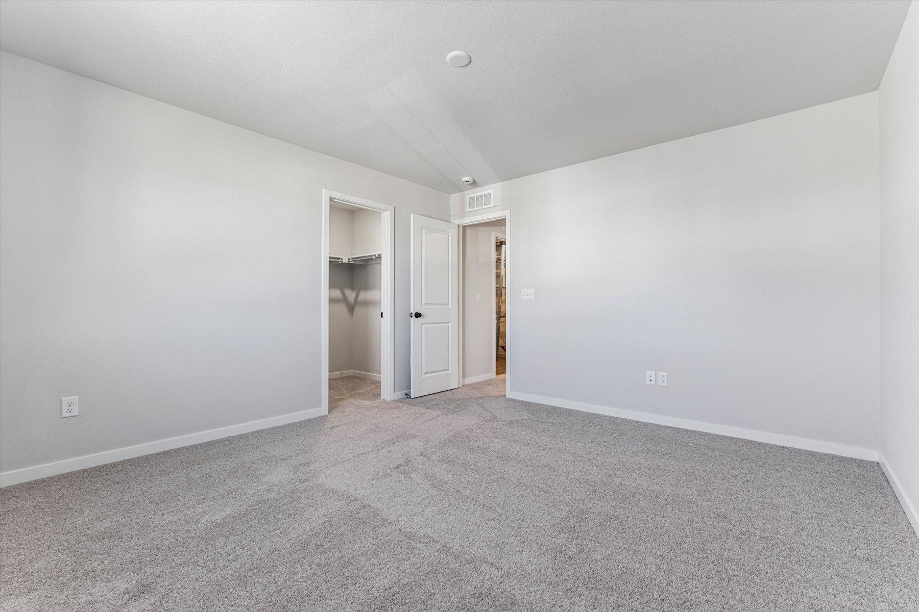 A hallway with white walls.