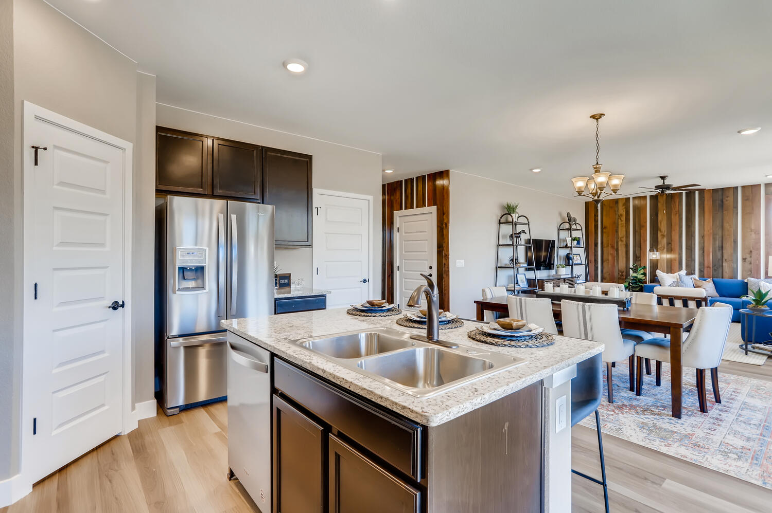 A kitchen with a dining table and refrigerator.