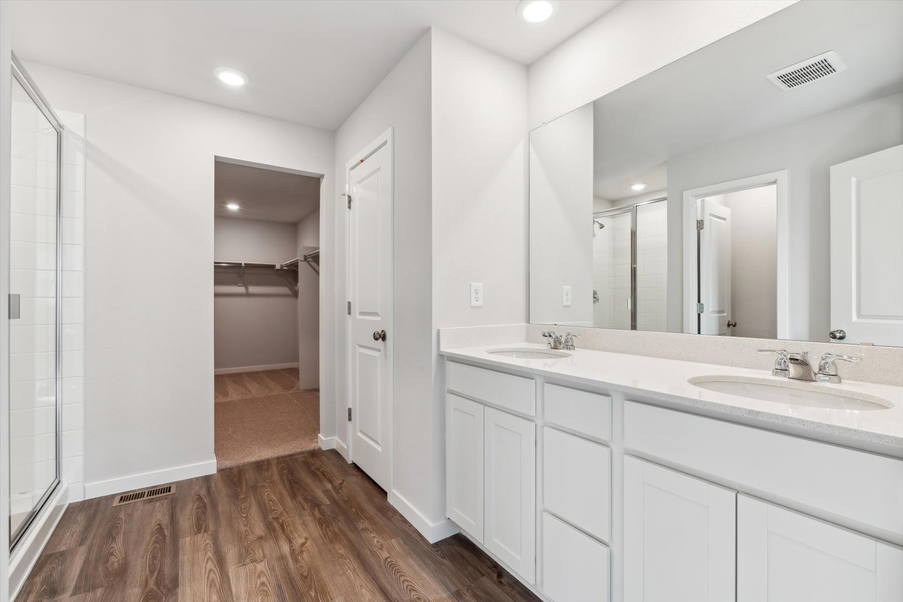 A bathroom with white cabinets.