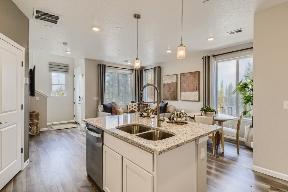 A kitchen with a marble island.
