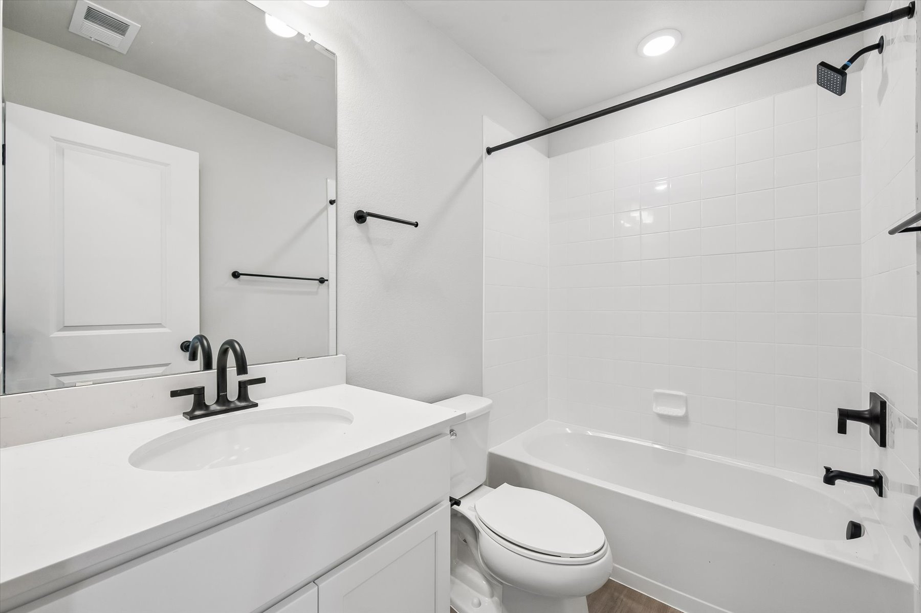 A bathroom with a tub sink and toilet.