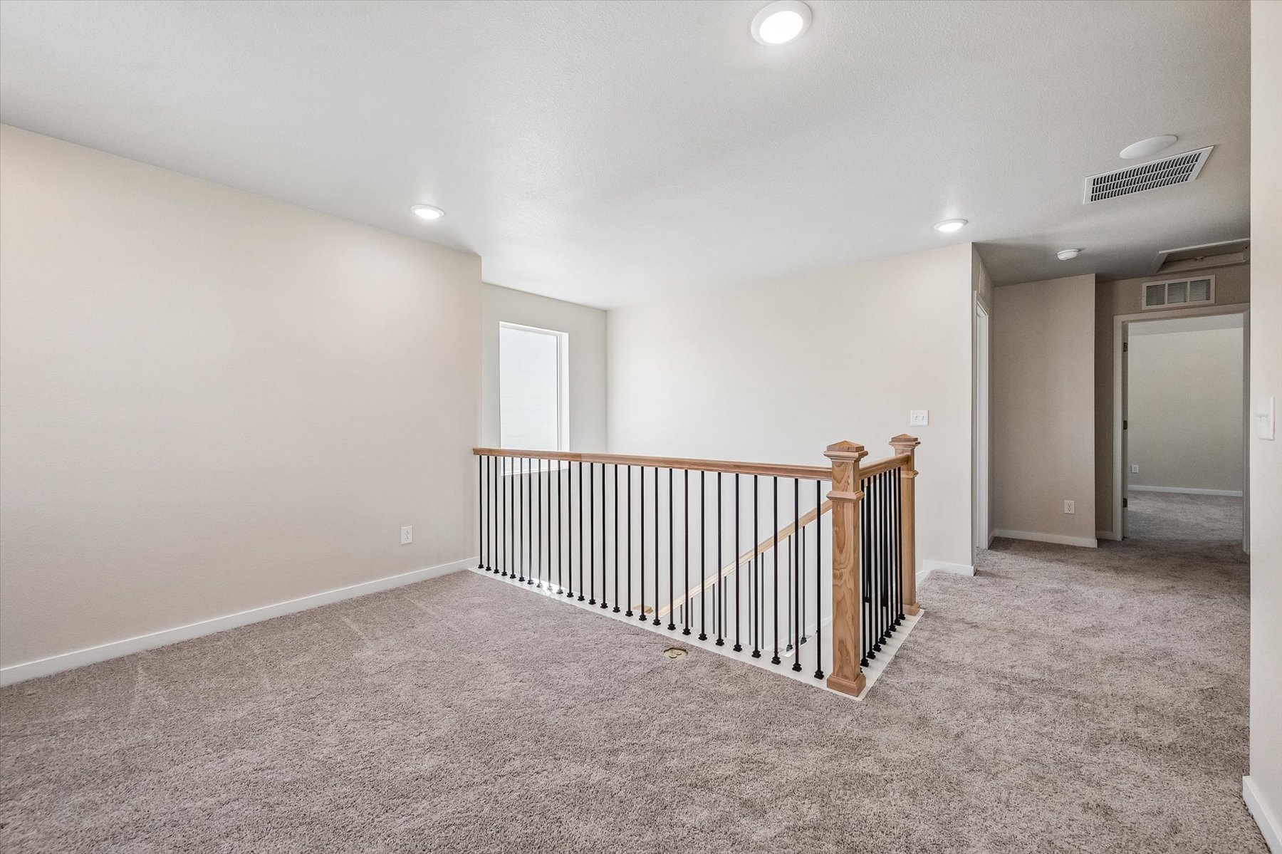 A room with a railing and a door.