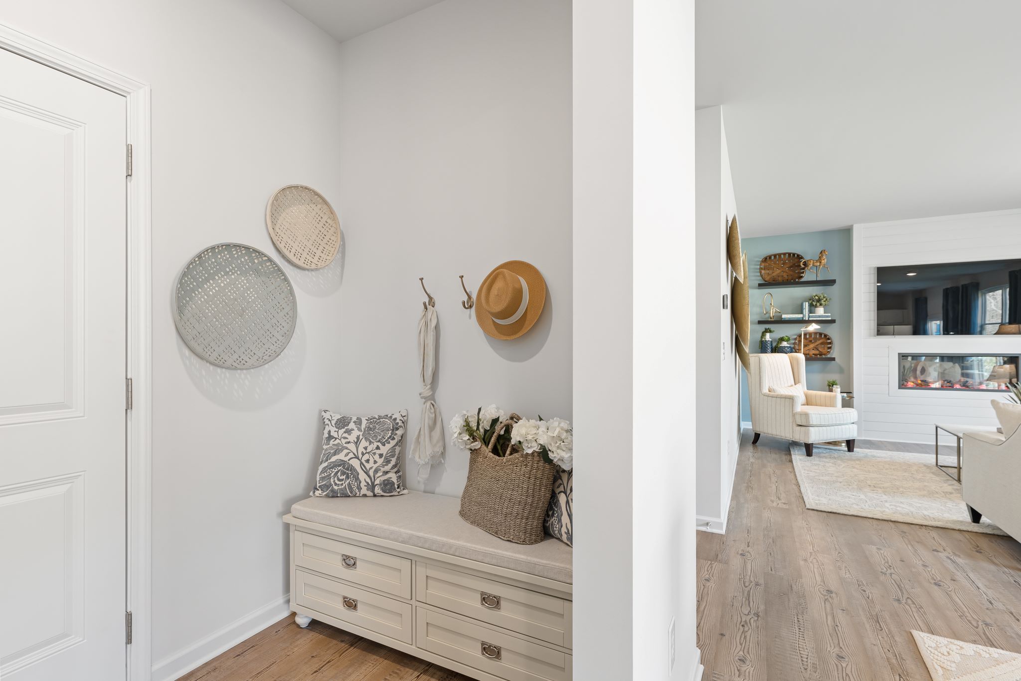 A room with a white wall and a white door with a white dresser and a white door with.