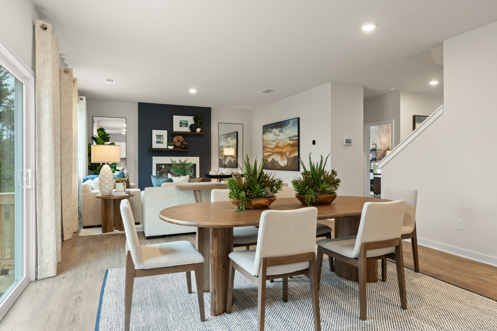 A dining room with a table and chairs.