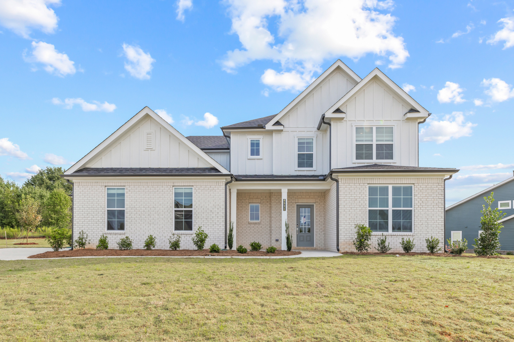 A house with a lawn in front.