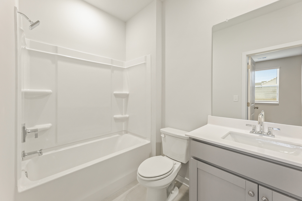 A bathroom with a tub toilet and sink.