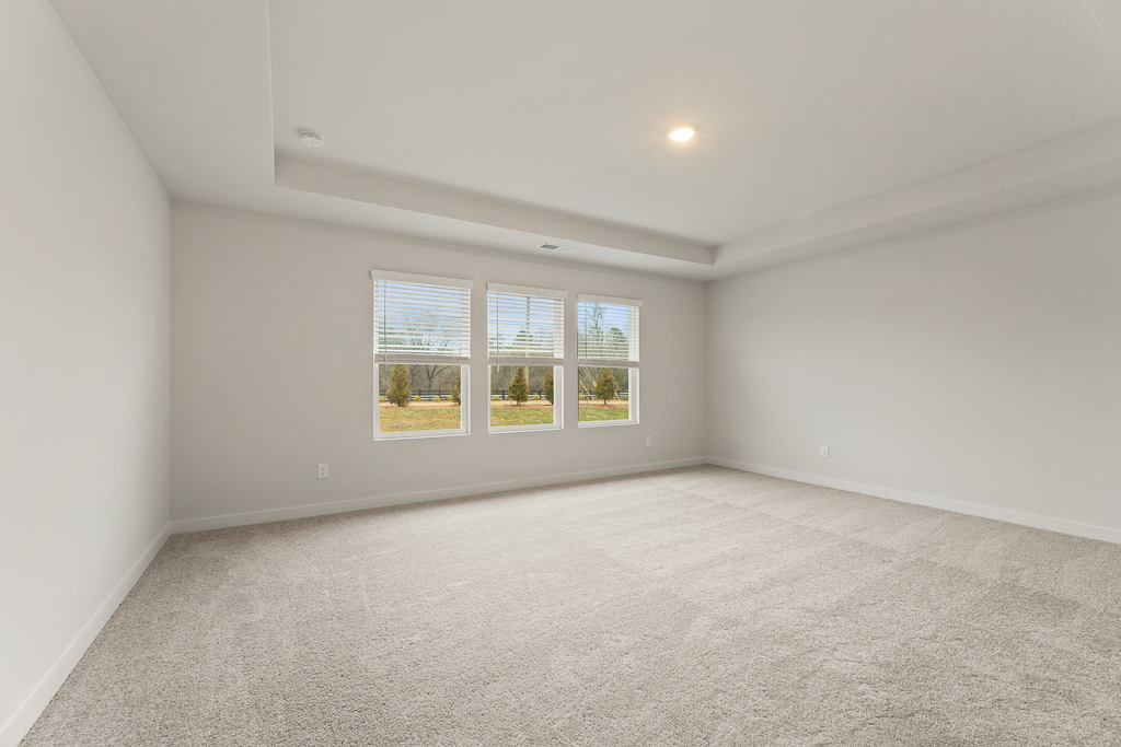 A room with a window and a carpet.