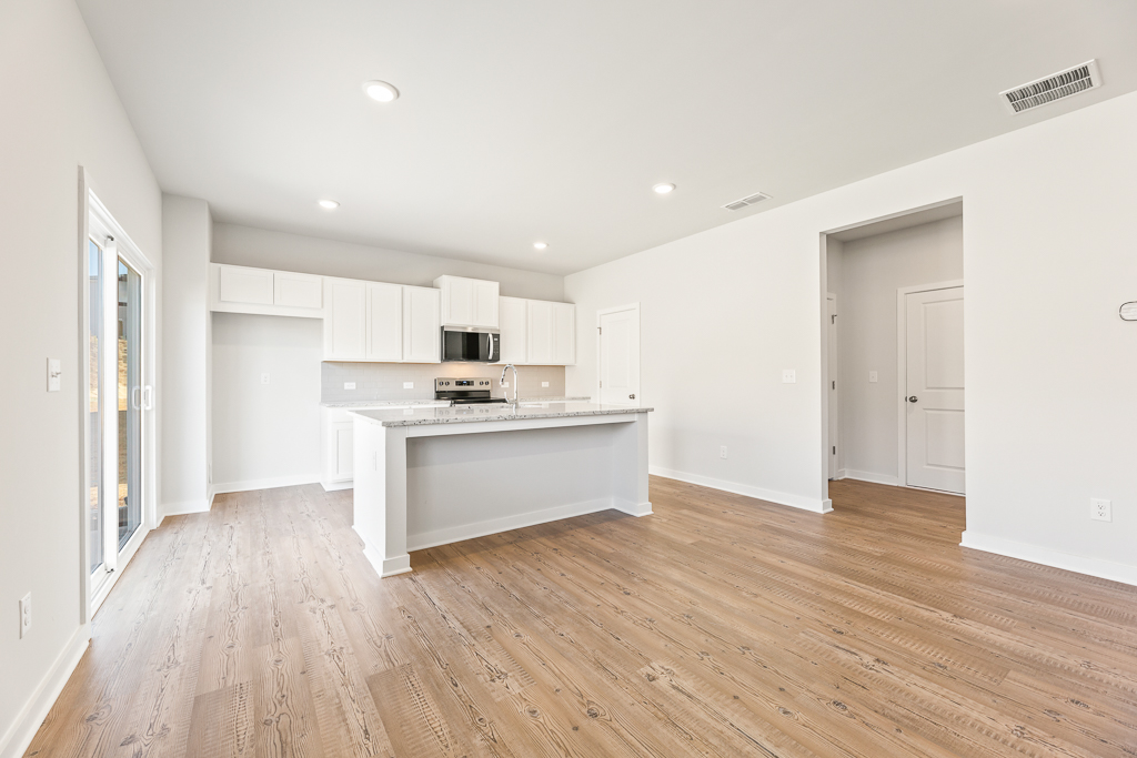 A kitchen with white cabinets.