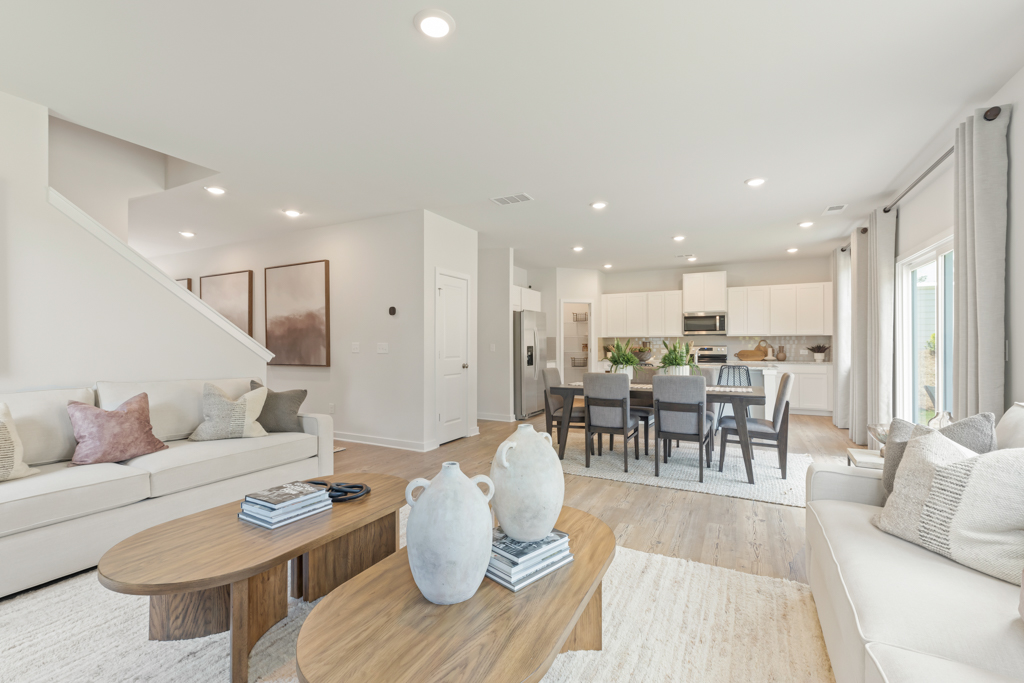 A living room with a table and chairs.