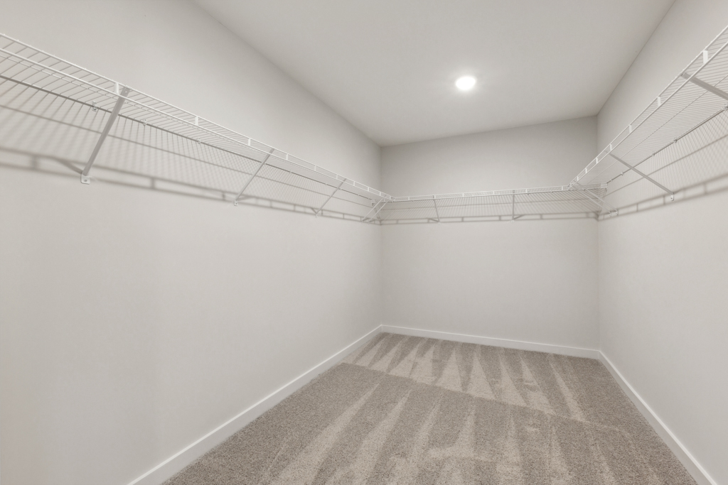 A white hallway with a rug.