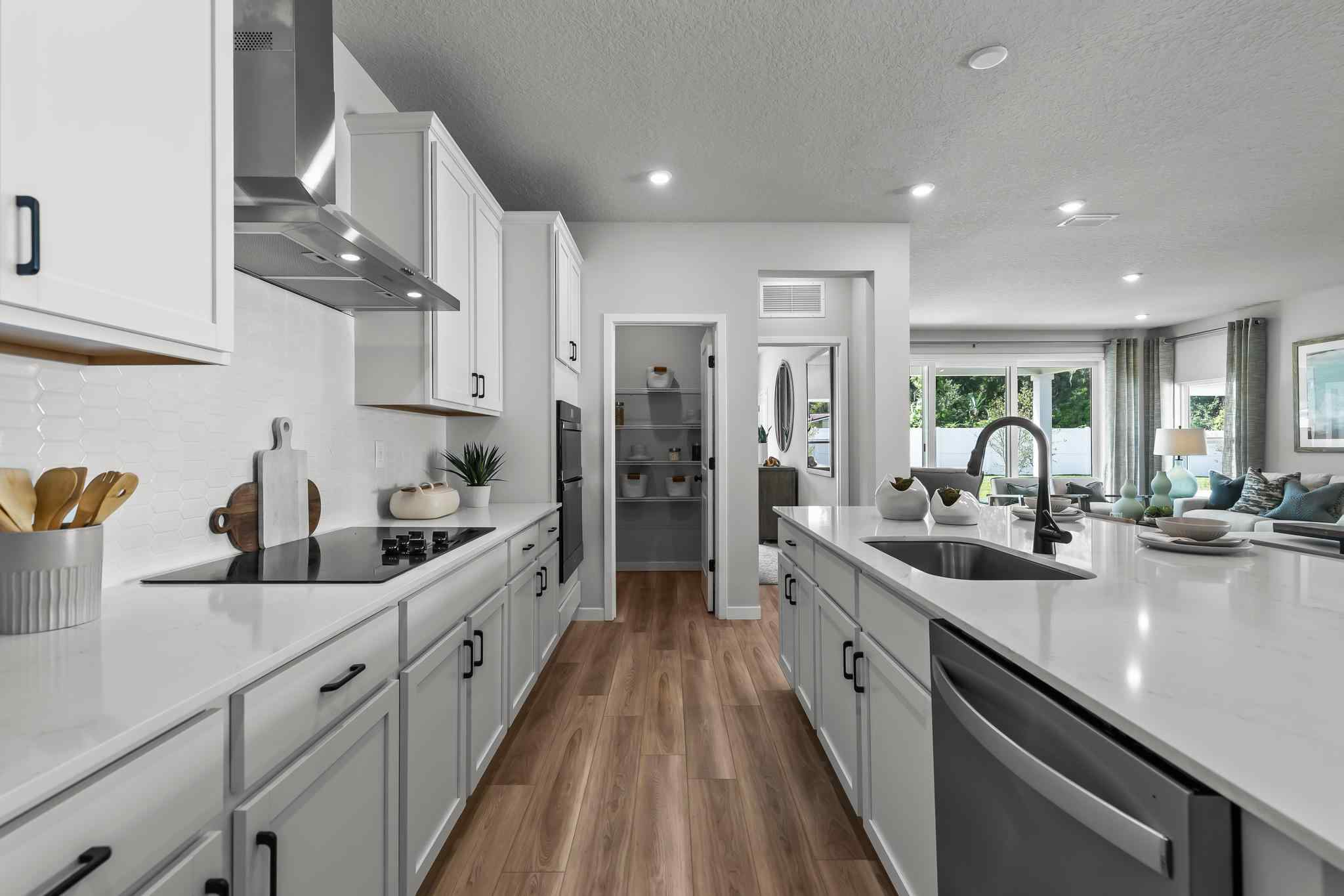 A kitchen with white cabinets.