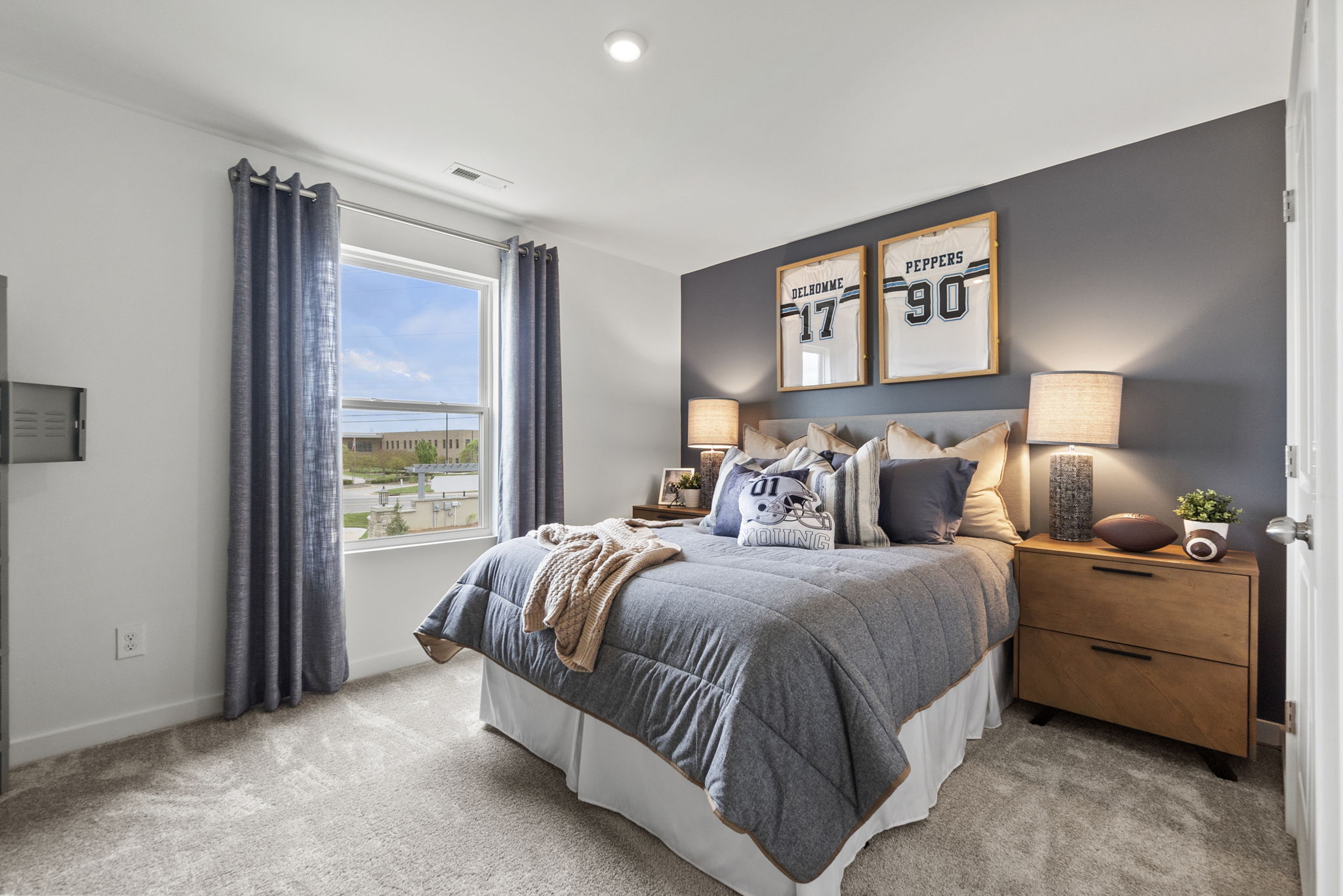 A bedroom with a bed and a window.