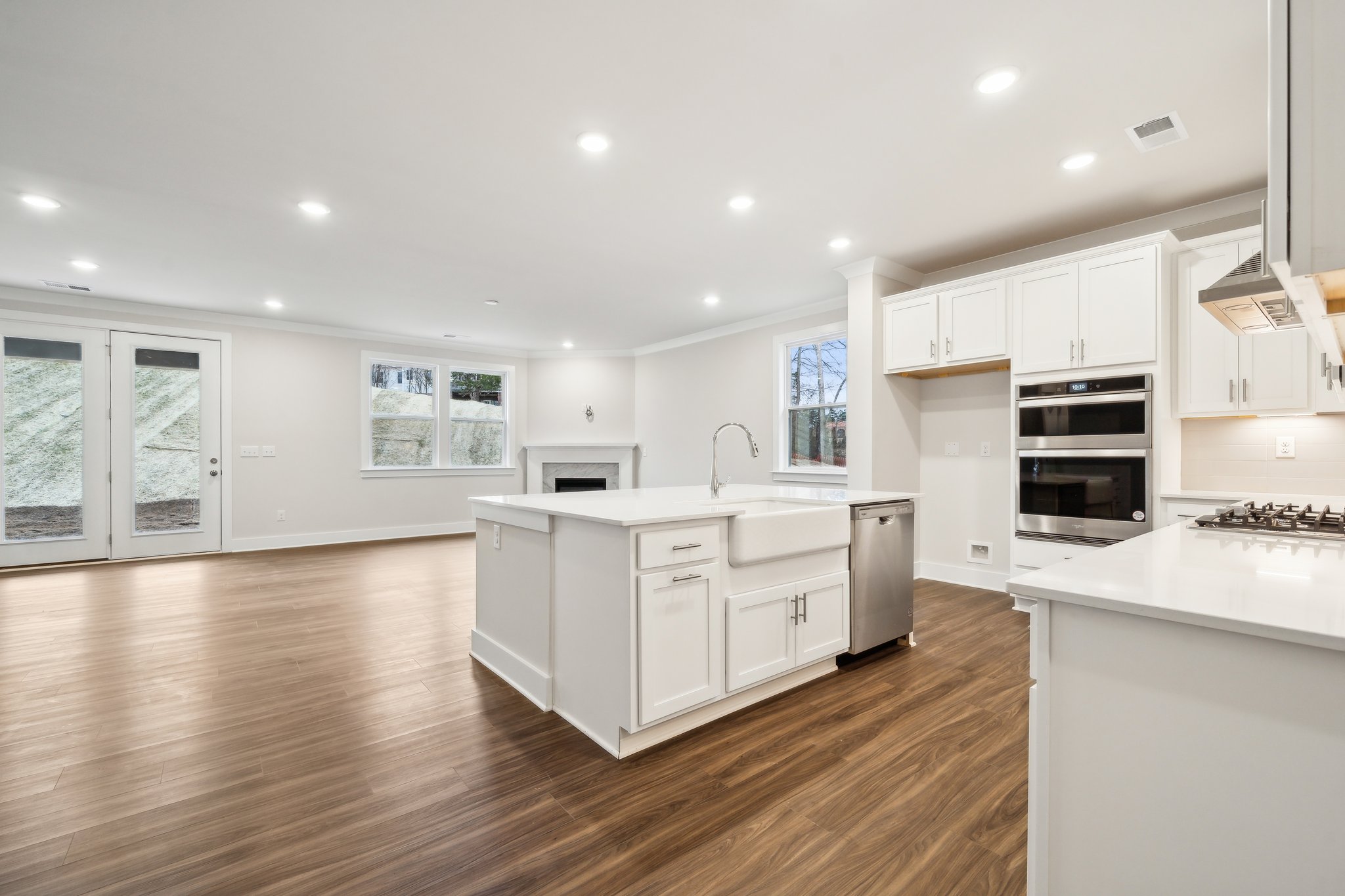A kitchen with white cabinets.