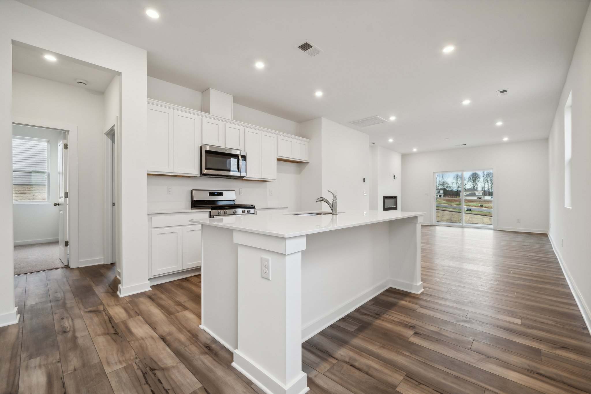 A kitchen with white cabinets.