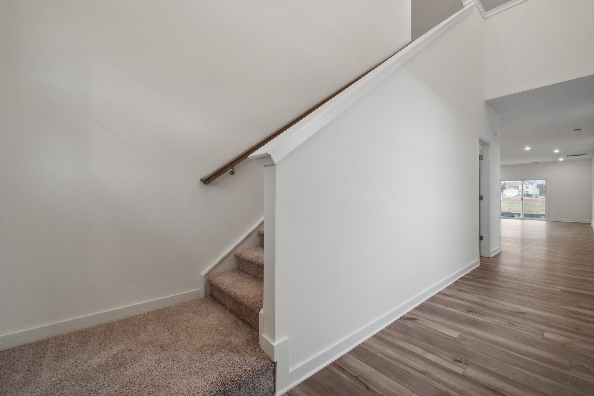 A room with a wood floor and white walls.